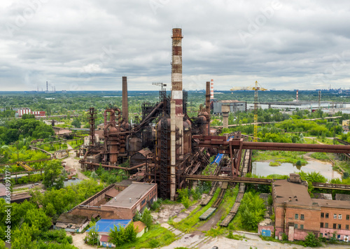 aerial photo of an old abandoned steel plant in the natural landscape