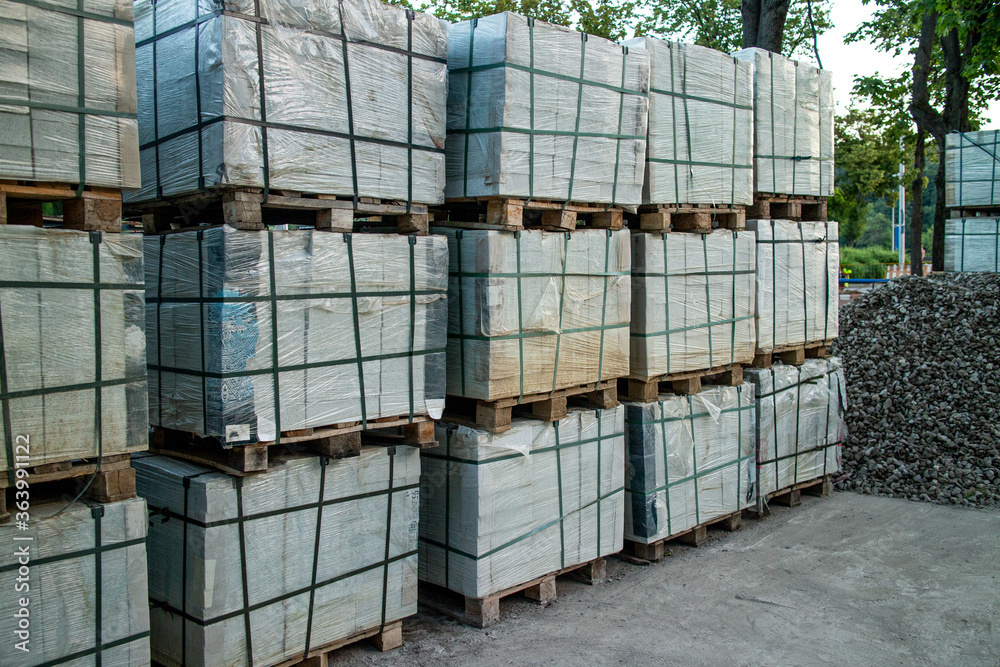 Pallets with tiles. Repair of the sidewalk, replacement of tiles in the city street. High quality photo Pallets with tiles. Repair of the sidewalk, replacement of tiles in the city street. High quality photo