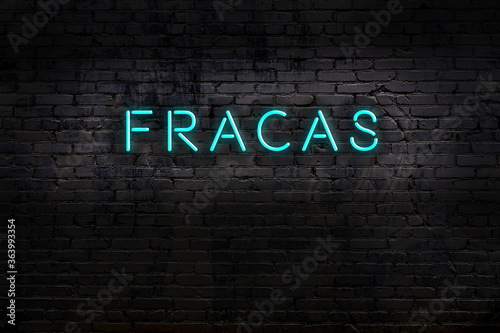 Night view of neon sign on brick wall with inscription fracas photo