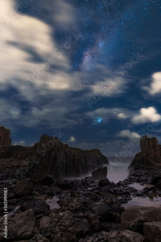 Milky way view with cloudy sky at Bombo Quarry, Kiama, NSW, Australia.