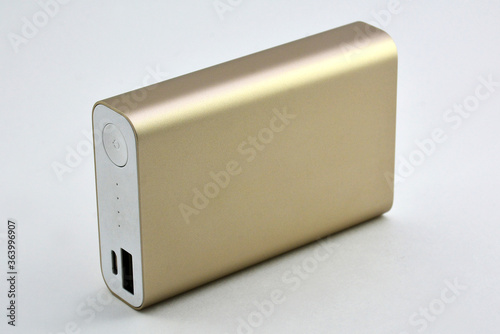 Gold portable powerbank with power button and charging indicator