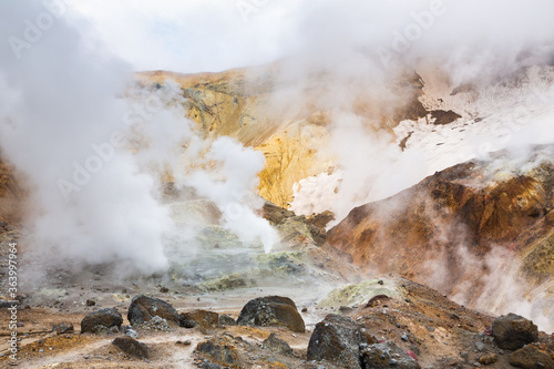 Volcanic landscape, crater of active volcano: hot spring, fumarole, lava field, gas-steam activity. Dramatic mountain landscape, popular travel destinations for active vacation, hiking, mount climbing