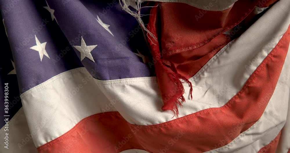 US flag faded torn old.