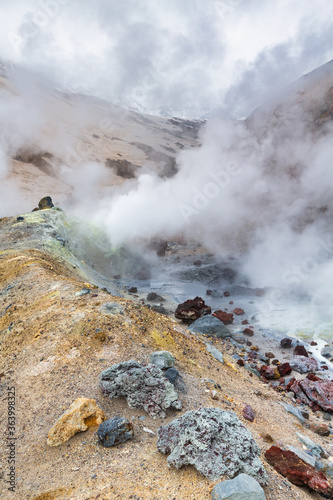 Mountain landscape, crater of active volcano: fumarole, hot spring, lava field, gas-steam activity. Dramatic volcanic landscape, popular travel destinations for active vacation, mount climbing, hiking