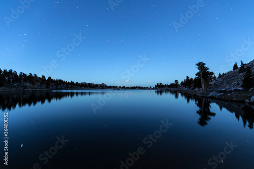 Star filled night view of Cirque lake in the Sierra Nevada Mountains near Lone Pine, California. © trekandphoto