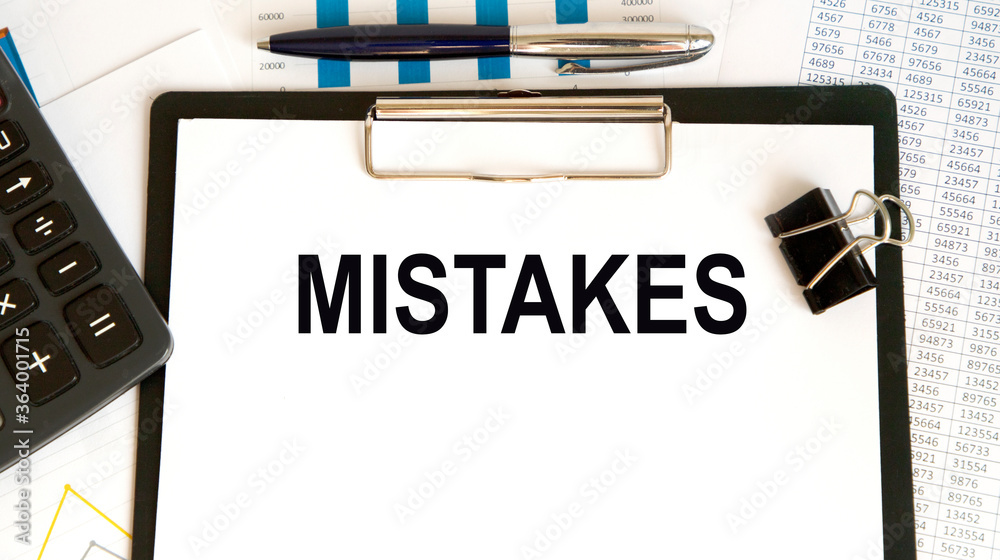 Fototapeta premium Wooden tablet with blank pages, crumpled paper balls and pencils on a white wooden background, creative writing concept. Minimalist writer workplace. High key still life with copy space.