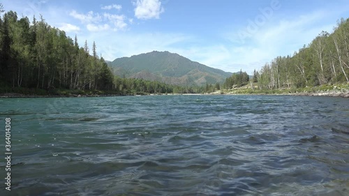 Video of mountain Altai landscape with river Katun on foreground and forest on the bank. photo