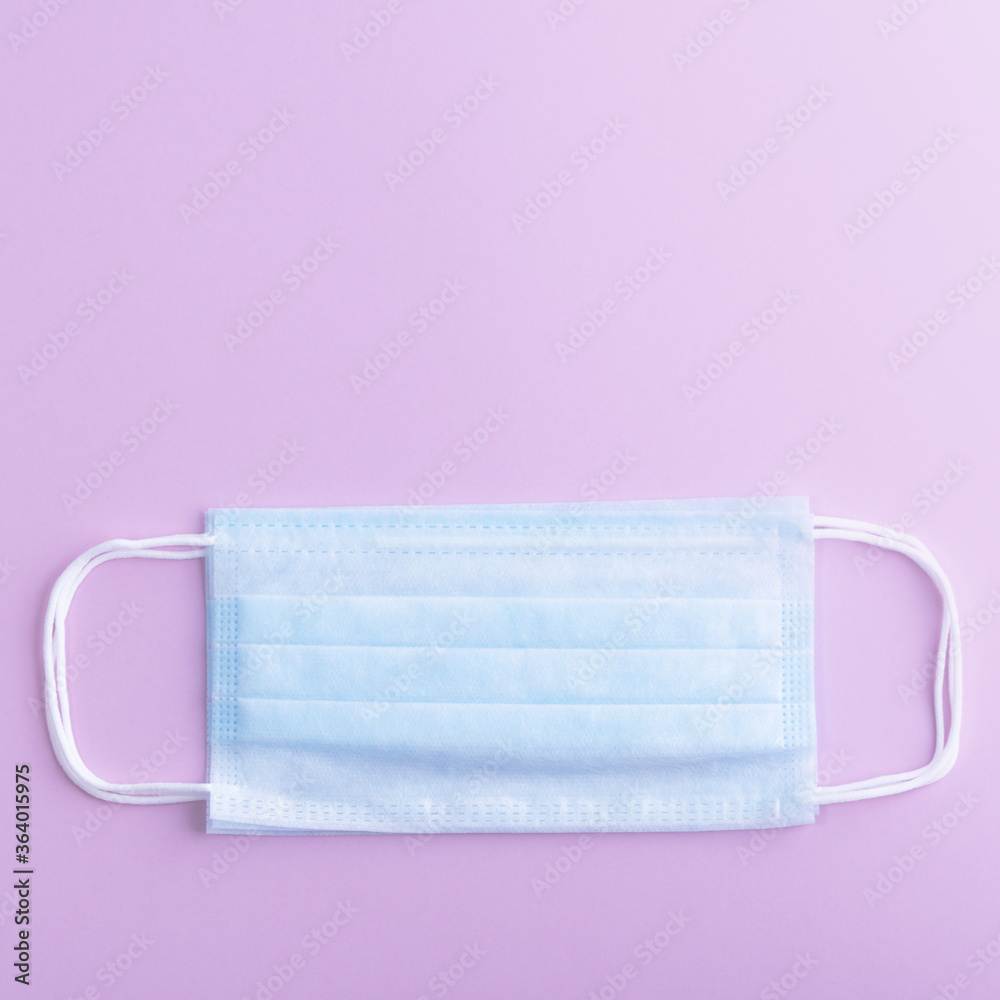 Medical mask protective virus, flu, disease. Isolated on a lilac background. Medical mask protective virus, flu, disease. Isolated on a lilac background.