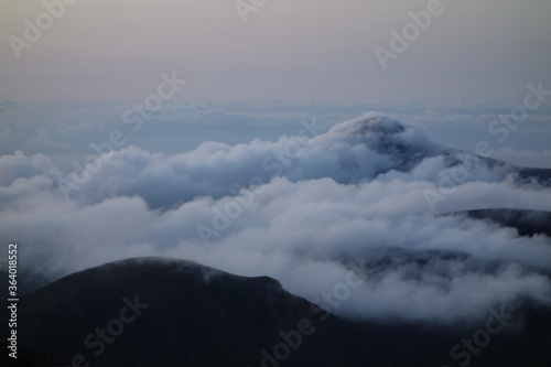 takachih-no-mine covering sea of clouds, one of the famous mountain where god came down and pierced the top by a big sword in Kirishima mountain range in the early morning, Miyazaki, Japan