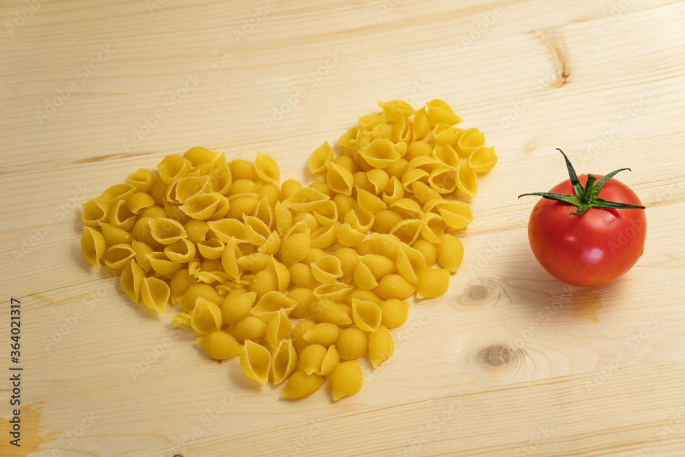 Love for pasta. Top view on the table. Product Layout. Ingredients for Italian pasta tomatoes, herbs, cherry.