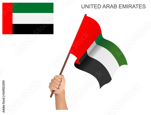 United Arab Emirates flag hoisted with a stick held by hand to inflame the spirit of statehood