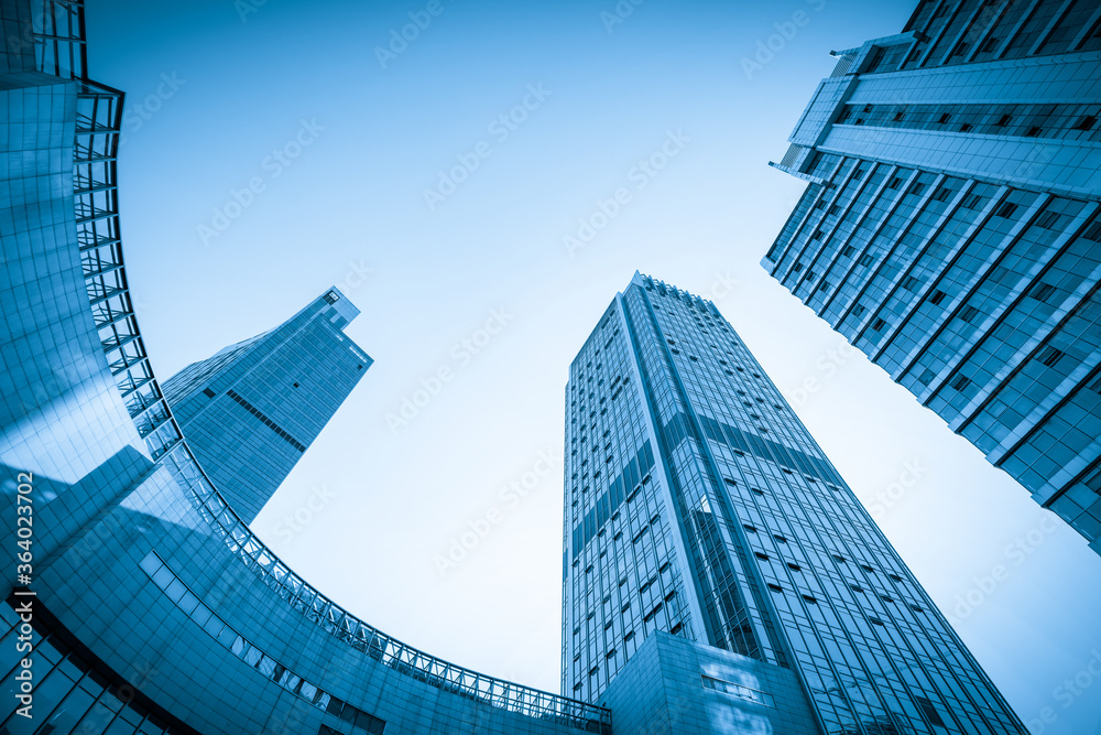 Naklejka premium Looking Up Blue Modern Office Building