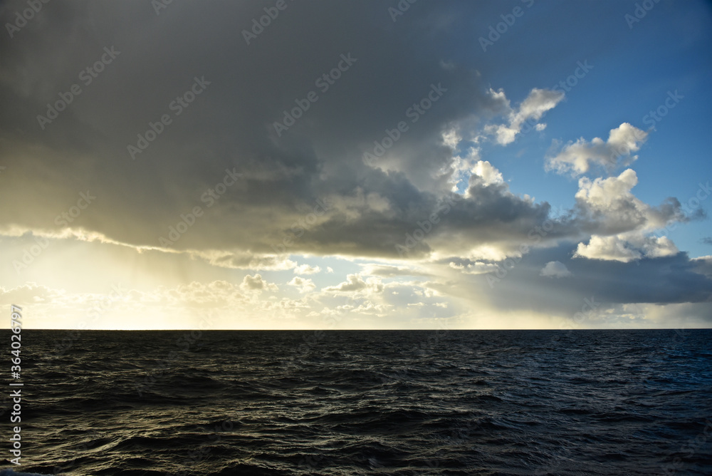 Epic cloud cover over the Pacific Ocean. Photo from the side of the ship. Autumn windy evening.