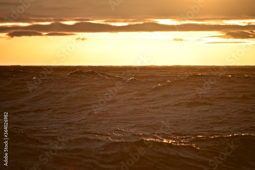 Low sun over the North Sea. Fall. Cold evening. Marine species. Photo from the side of the ship.
