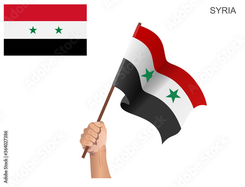 Syrian state flag raised with a stick held by hand to inflame the spirit of statehood