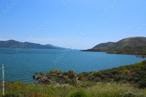 aerial view of Diamond Valley Lake with deep blue green lake water, blue skies, and clouds photo