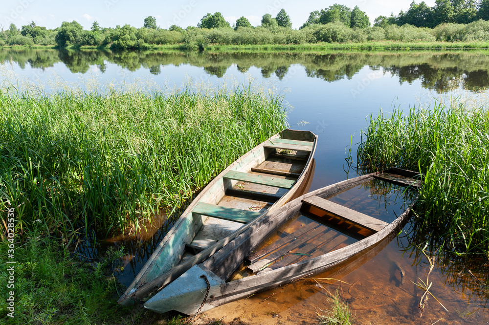 Summer landscape. Nature. Two wooden boats by the river Summer landscape. Nature. Two wooden boats by the river