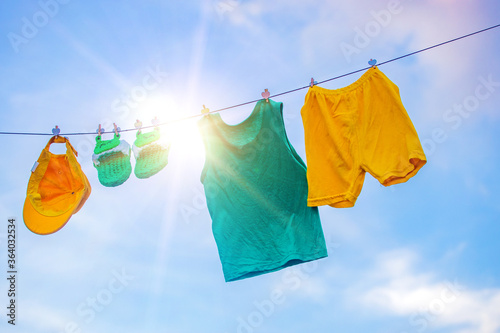 Sun drying homemade children's cloth, slippers and clothes