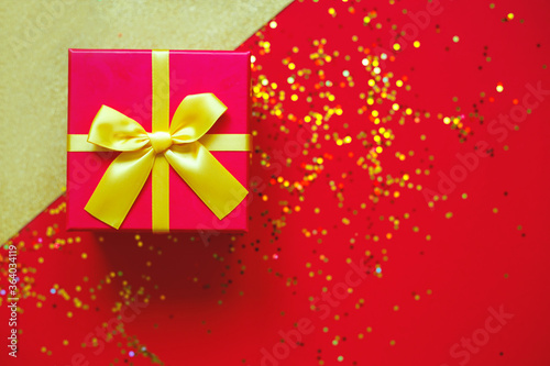gift box with bow on red-gold background