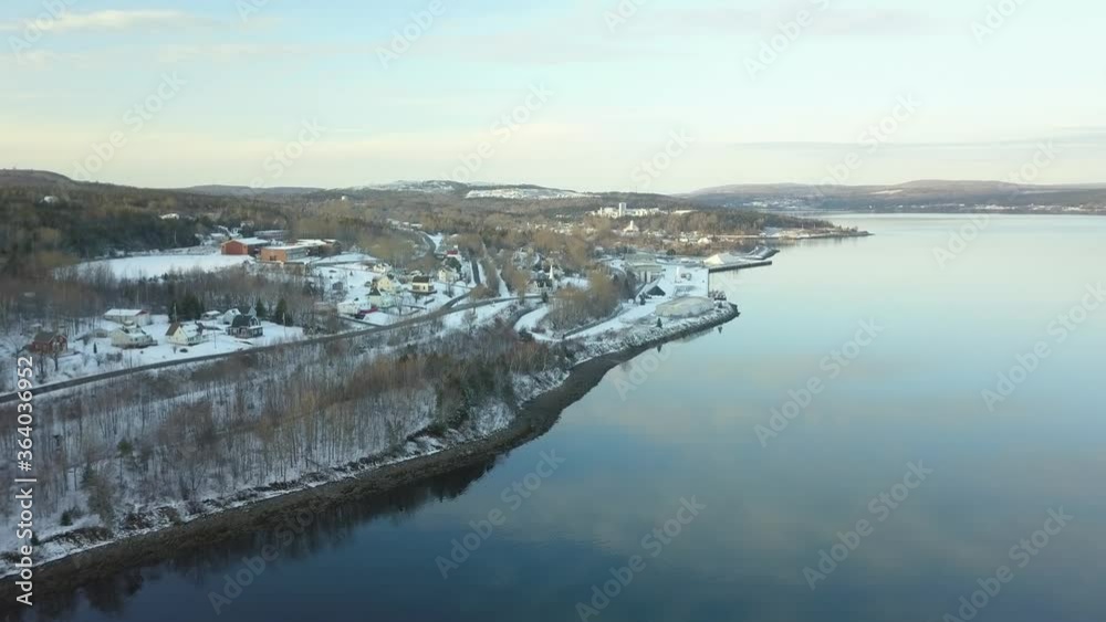 Aerial Shot of snowing forested village with water Nova Scotia Canada Aerial Shot of snowing forested village with water Nova Scotia Canada