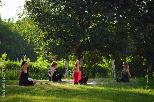 women in the Park with an instructor doing yoga