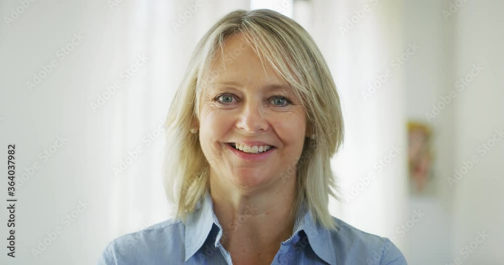 Authentic close up of an attractive mature blond hair woman with blue ...