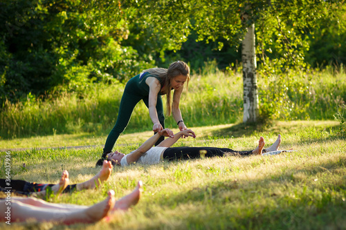 women in the Park with an instructor doing yoga