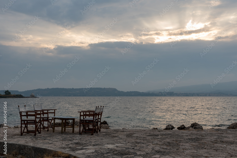 Small tables of a restaurant by the Greek sea Small tables of a restaurant by the Greek sea