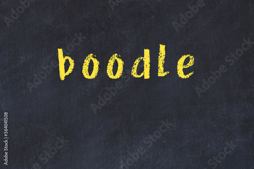 College chalk desk with the word boodle written on in photo