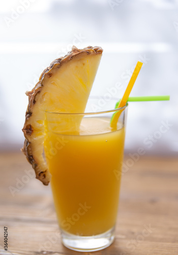 pineapple juice in a glass with a slice of pineapple