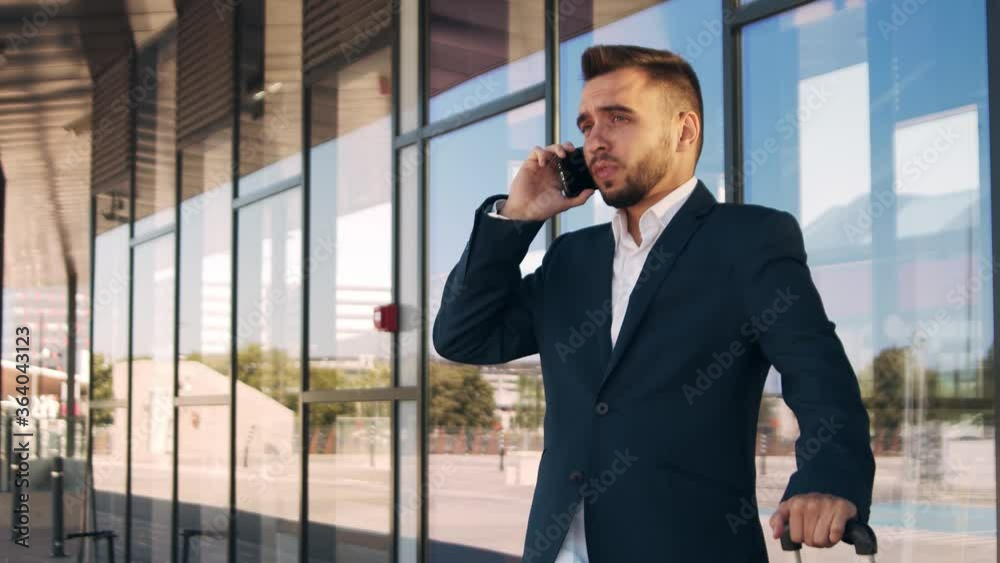 Elegant businessman in airport. Young mail entrepreneur in formalwear. Business trip and traveling. Elegant businessman in airport. Young mail entrepreneur in formalwear. Business trip and traveling.