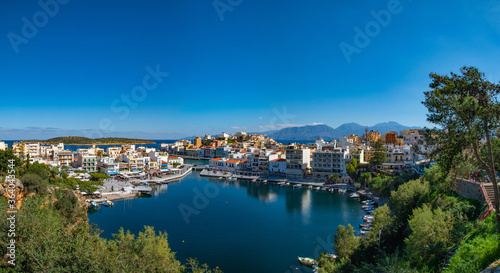 Agios Nikolaos, Crete, Greece. Agios Nikolaos is town in the eastern part of the island Crete in bay of Mirabello. Voulismeni lake. HD Panoramic view. © Artem