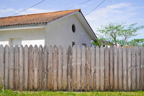 home palisade wooden fence to hide the neighbor from house