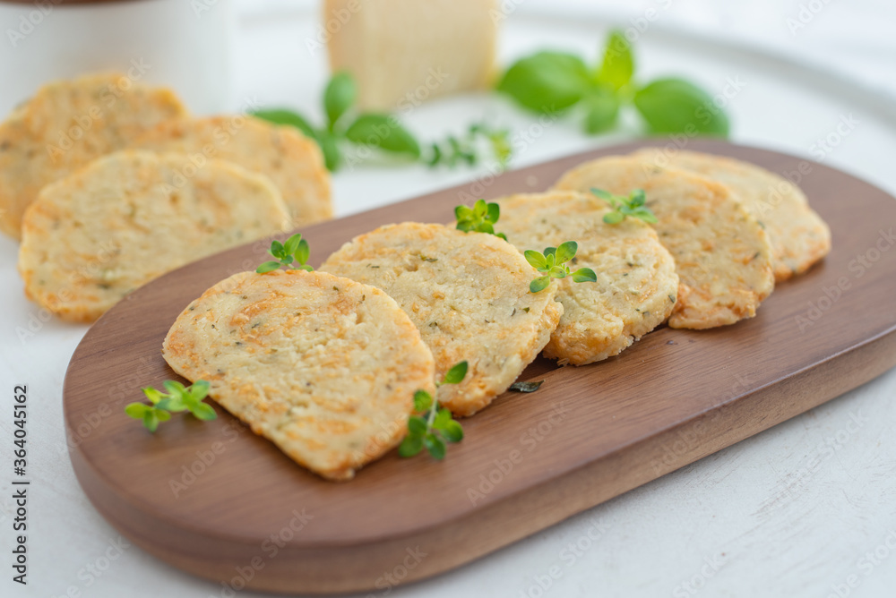 home made cheese crackers with herbs on a table home made cheese crackers with herbs on a table