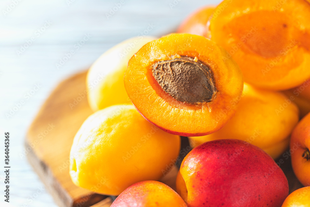 Ripe fresh apricots on a wooden background. Summer fruit concept. Rustic style.