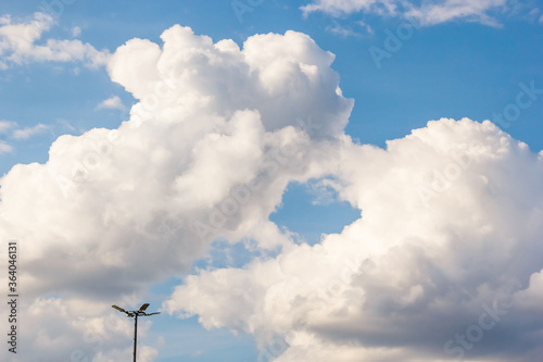 cumulus and high-cumulus clouds of an average tier on blue heavenly space