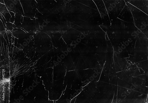 Broken window glass. Fractured texture. Black crashed computer screen with white dust scratches.