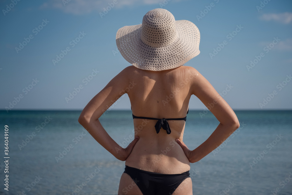 Beautiful Young Woman At Beach Wearing Hat