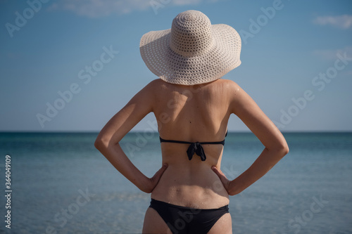 Beautiful Young Woman At Beach Wearing Hat