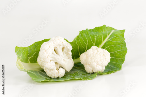 close-up of delicious white cauliflower on a leaf illustrating a healthy lifestyle isolated on white background photo