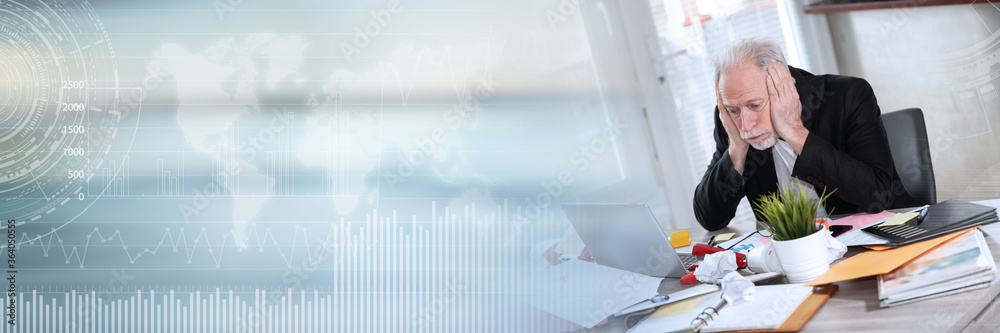 Overworked businessman sitting at a messy desk; panoramic banner
