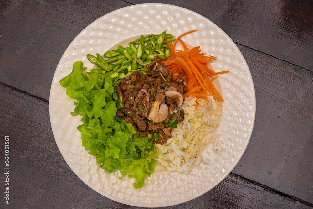 stewed mushrooms with onions and garlic and spices, vegetarian food, handmade food on a wooden table in a white plate