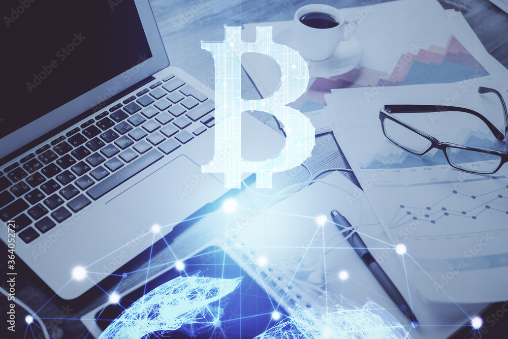 Double exposure of blockchain and crypto economy theme hologram and table with computer background. Concept of bitcoin cryptocurrency. Double exposure of blockchain and crypto economy theme hologram and table with computer background. Concept of bitcoin cryptocurrency.