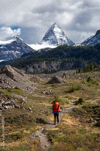 Adventure Backpacking in the Iconic Mt Assiniboine Provincial Park near Banff, Alberta, Canada. Girl Hiker with Canadian Mountain Landscape in Background.