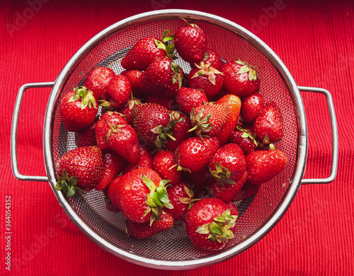 Fresh washed strawberries in a sieve