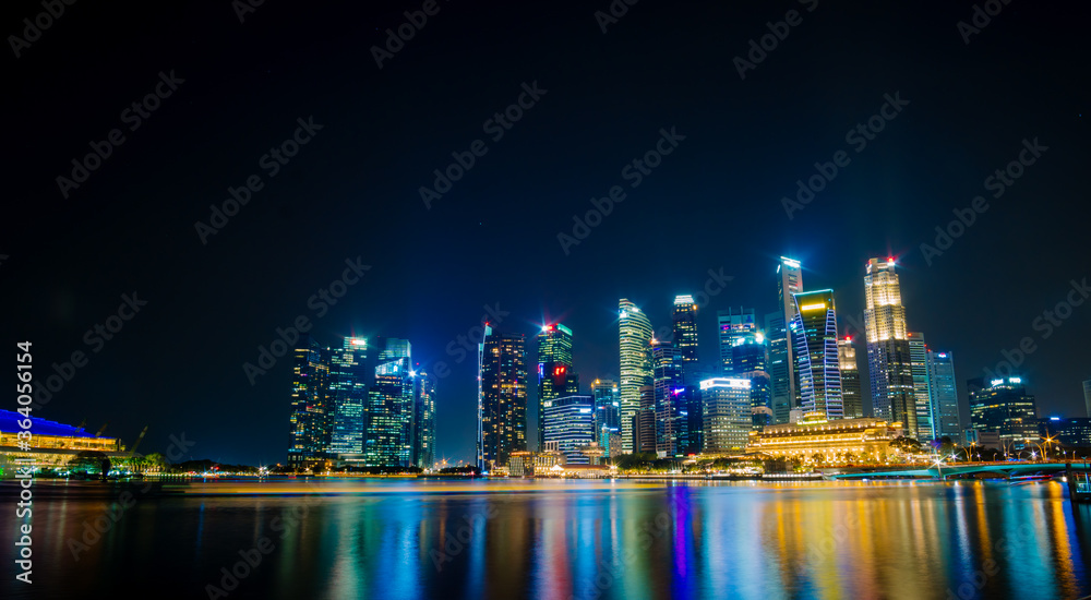 Beautiful architecture building skyscraper around marina bay in singapore city at night.