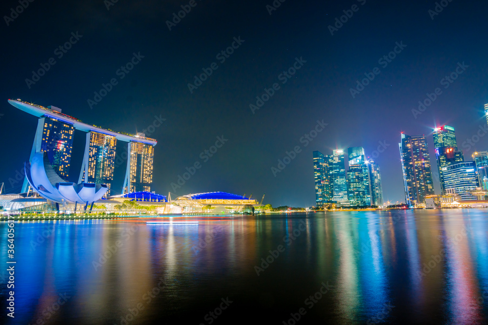 Fototapeta premium Beautiful architecture building skyscraper around marina bay in singapore city at night.