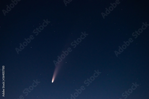 Obraz na płótnie View of the C/2020 F3 (NEOWISE) comet close-up at night among the stars. The brightest C/2020 F3 (NEOWISE) comet in the last few years. Large dusty tail of a C/2020 F3 (NEOWISE) comet close-up . w salonie