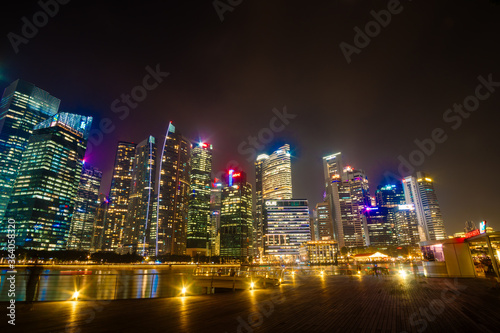 Beautiful architecture building skyscraper around marina bay in singapore city at night. © PhetcharatBiRTH