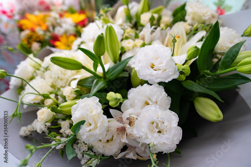 white lilies and carnations. top view of bouquets of fresh flowers.